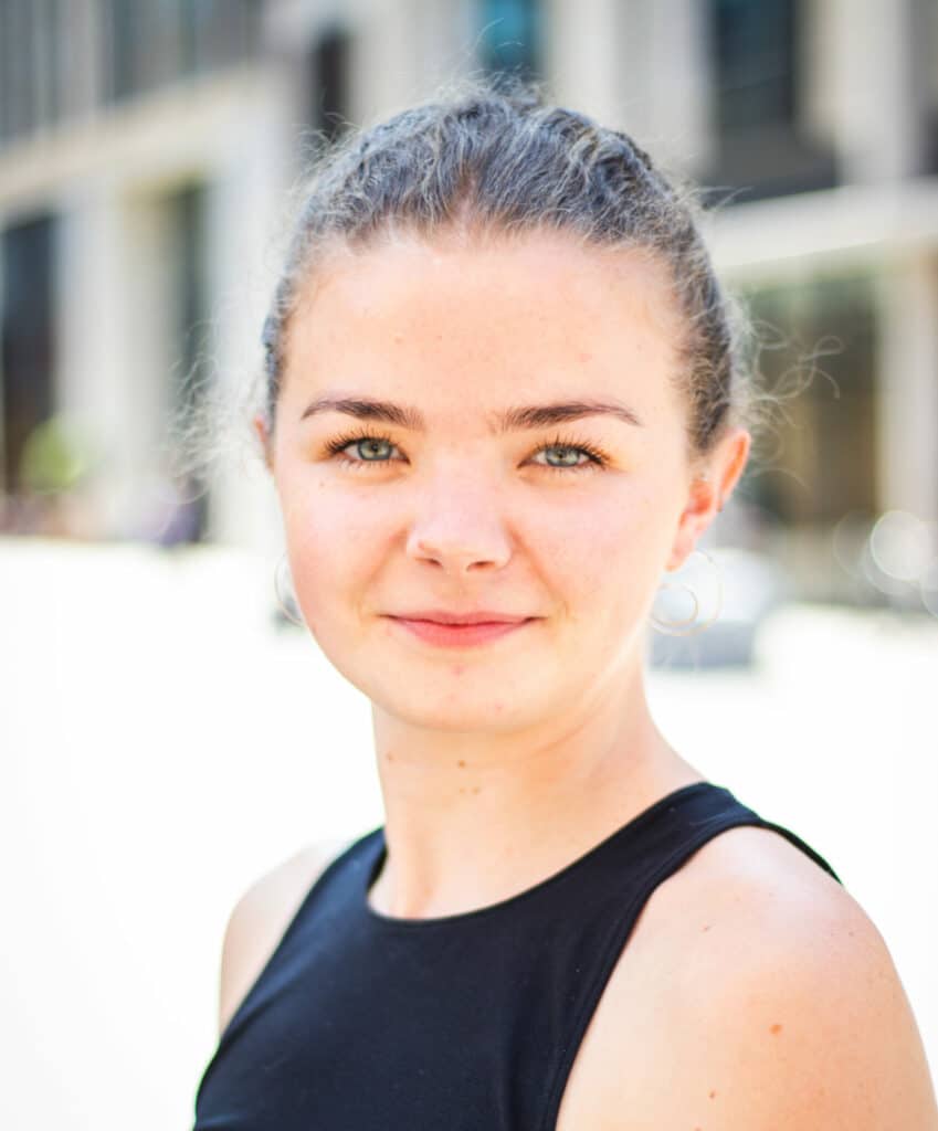 Image of a women with a still focused facial expressions. Professional image with blurry background