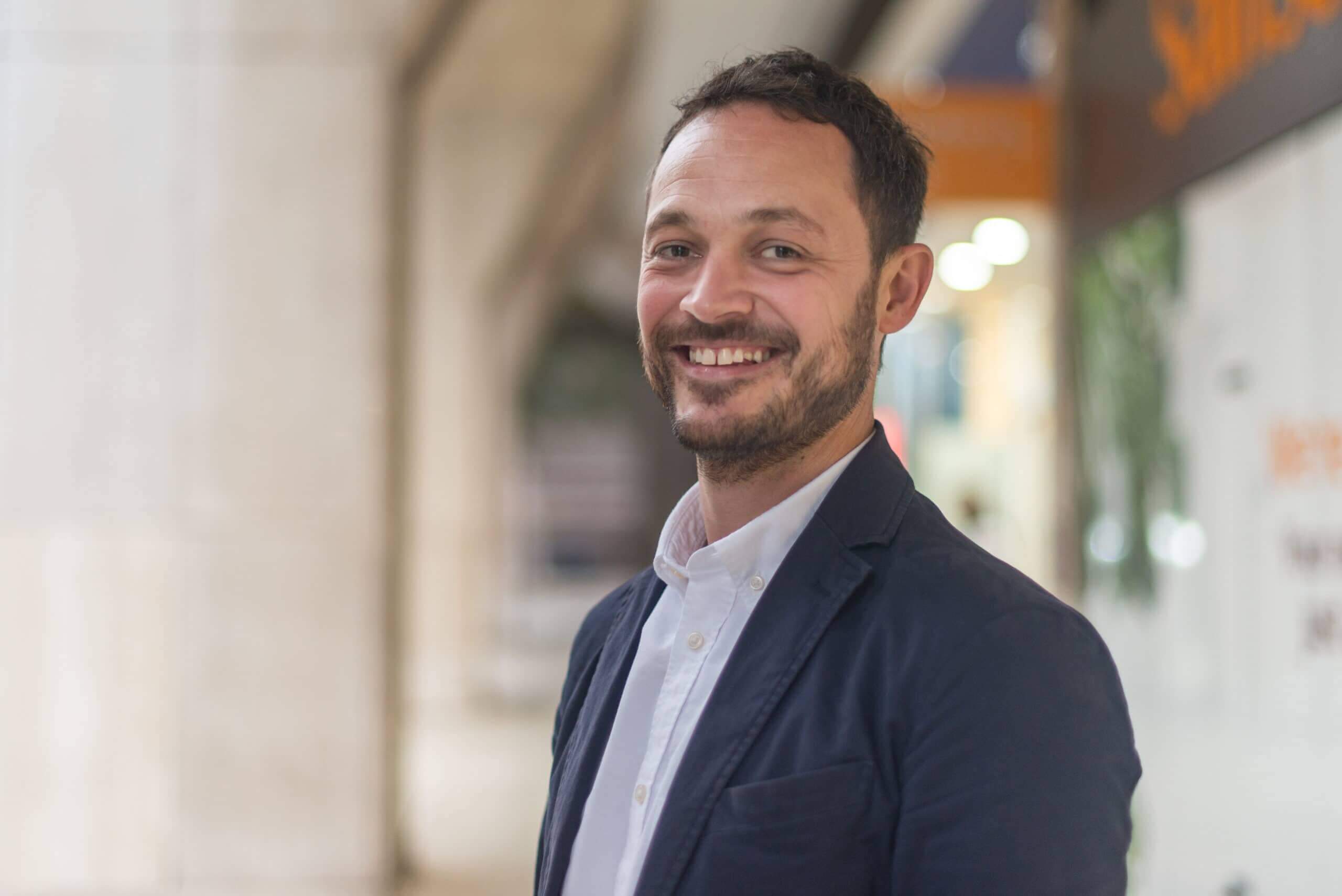 A smiling man with a suit